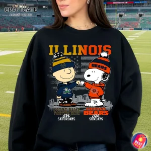 A woman at a football stadium wearing the black Illinois fan sweatshirt with the Notre Dame and Chicago Bears Snoopy design.