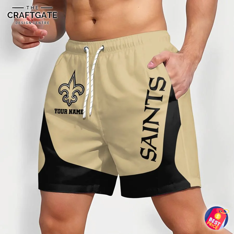 Personalized New Orleans Saints NFL Shorts for Fans (Angled View) An angled view of a man wearing custom New Orleans Saints shorts, highlighting the "SAINTS" text on the side and the overall fit.