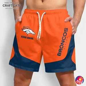 A man wearing custom NFL Denver Broncos shorts in orange and navy blue, showing the team logo and personalized name option.
