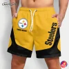 A man wearing yellow and black custom Pittsburgh Steelers shorts with the team logo and a placeholder for a custom name on the front.