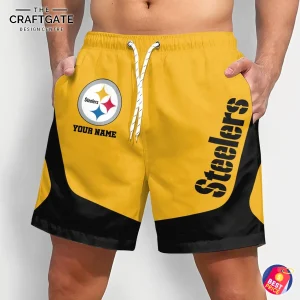 A man wearing yellow and black custom Pittsburgh Steelers shorts with the team logo and a placeholder for a custom name on the front.