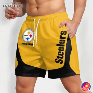 An angled side view of a man wearing custom Pittsburgh Steelers shorts, showing the team name down the leg and the logo on the thigh.