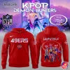 A red San Francisco 49ers hoodie showing the front with the 49ers logo and the back with a KPop Demon Hunters group graphic.