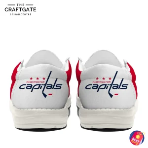Rear view of a pair of Washington Capitals loafer shoes, showing the team's wordmark logo with a hockey stick on the white heel.