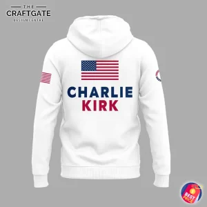 Back view of the white hoodie showing an American flag and the name CHARLIE KIRK printed in bold blue and red letters.