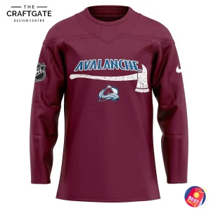 A close-up of the front of the burgundy Colorado Avalanche jersey featuring an axe graphic and the team logo.