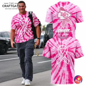 Front view of a pink tie-dye 3D T-Shirt with a white ribbon design, worn by a person walking on a city sidewalk.