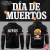 Promotional image showing the front and back of the LA Kings Día De Muertos hoodie with a sugar skull and skeleton design.