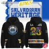 A promotional image showing the front and back of the black Los Angeles Kings Salvadoran Heritage 2025 Hoodie.