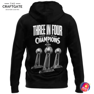 Back of the black Las Vegas Aces hoodie featuring the text "Three in Four 2025 WNBA Champions" above three trophy graphics.