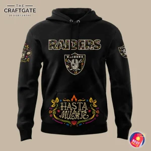 A close-up of the front of the Las Vegas Raiders hoodie, showing the team logo and colorful Hasta la Muerte pocket design.