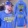 A Milwaukee Brewers player wearing the blue "Jesus Won" hoodie, next to mockups showing the front and back "This Is My Crew" design.