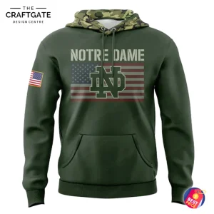 Front view of an olive-green camo hoodie with "NOTRE DAME" and ND logo over a US flag graphic, plus a flag patch on the sleeve.