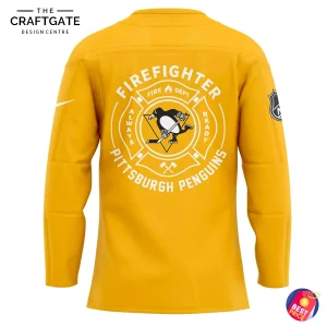 The back of the yellow Pittsburgh Penguins Firefighter jersey, showing a large Fire Dept style crest with the team logo.