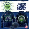 Promotional image of the Seattle Seahawks Indigenous Peoples Day hoodie, showing front, back, and matching cap with tribal art.
